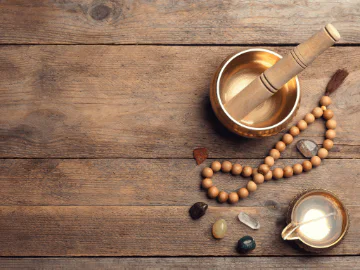 A sound therapy bowl next to crystals and jewellery