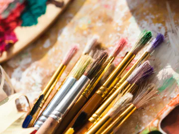 paint and paint brushes with an artist palette