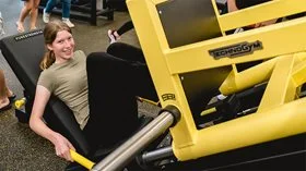 A young person using a leg press machine at Swan Active Midland