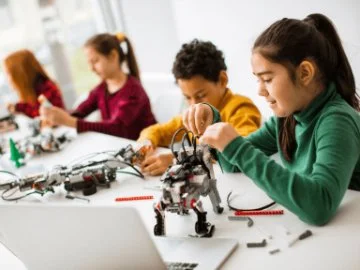 Children building robots out of Lego