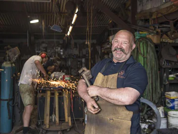 Martin standing in a shed for welding and sculpting
