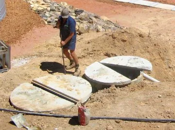 A worker installing a septic system at a worksite