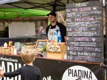 A food van at the Avon Descent carnival with customers being served food