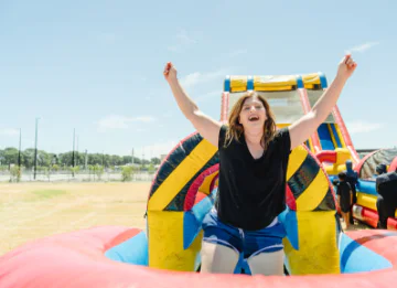 Tanya Richardson, City of Swan Mayor celebrates on a waterslide