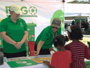 People at a FOGO booth during a community event