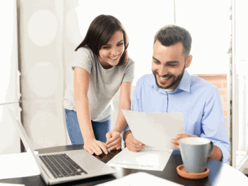 A couple completing their tax at a desk