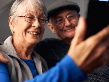 A senior couple using a mobile phone